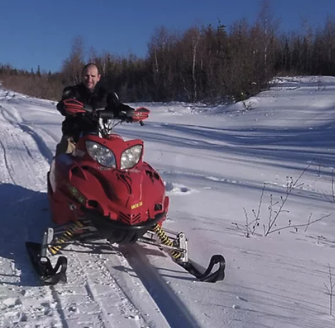 a man that is sitting in the snow