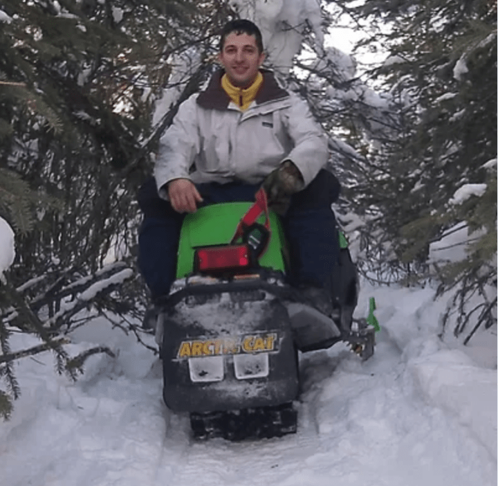 a person sitting on a pile of snow